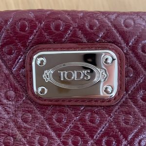 NWOT- Tod’s Aubergine Wristlet.  Leather.  Never used.